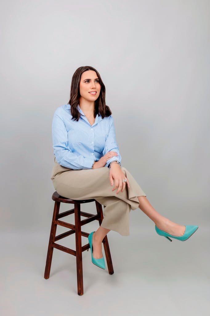 Bia The Realtor seated with phone and coffee